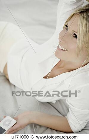 Woman with music player. View Large Photo Image Stock Image - Woman with music player.. Fotosearch