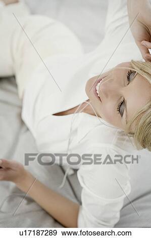 Stock Photo - Woman with music player.. Fotosearch