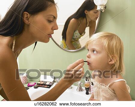 Stock Image - Mother and daughter applying makeup.. Fotosearch