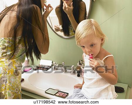 Mother and daughter applying makeup. View Large Photo Image Stock Image - Mother and daughter applying makeup.. Fotosearch