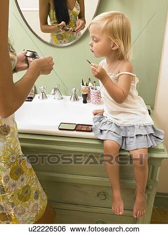 Mother and daughter applying makeup. View Large Photo Image Stock Photograph - Mother and daughter applying makeup.. Fotosearch