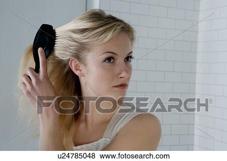 Portrait of a woman with a hairbrush. View Large Photo Image Stock Photo - Portrait of a woman with a hairbrush.. Fotosearch