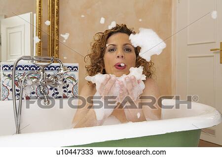 woman blowing lather from hands in bath, portrait View Large Photo Image Stock Image - woman blowing lather from hands in bath, portrait. Fotosearch