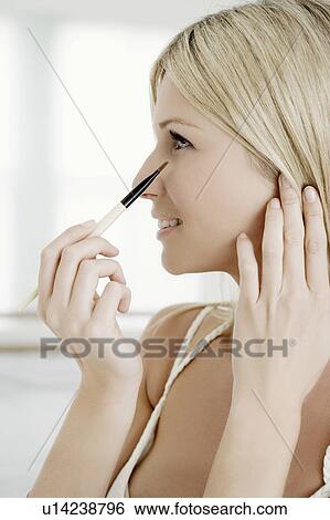 Stock Photograph - Woman with eye shadow brush.. Fotosearch