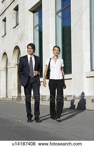 Businessman and woman walking on street in city frontal view. View Large Photo Image Stock Photo - Businessman and woman walking on street in city frontal view.. Fotosearch