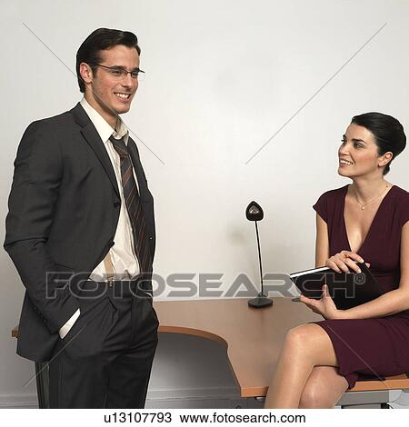 Man and woman in office, smiling View Large Photo Image Stock Image - Man and woman in office, smiling. Fotosearch