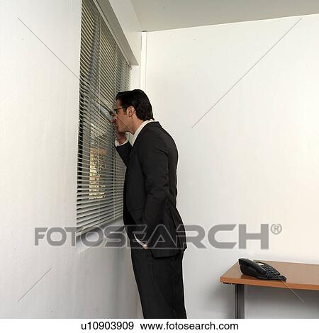 Man looking out window View Large Photo Image Stock Photo - Man looking out window. Fotosearch