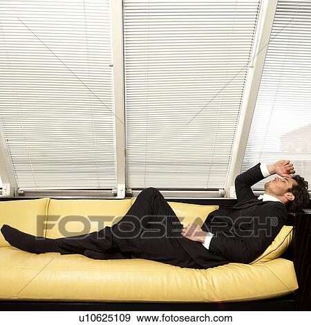 Man on sofa, eyes closed View Large Photo Image Stock Photo - Man on sofa, eyes closed. Fotosearch