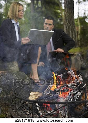 Business meeting by a camp fire View Large Photo Image Stock Photo - Business meeting by a camp fire. Fotosearch