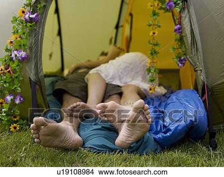 Picture - Feet of man and woman laying together. Fotosearch
