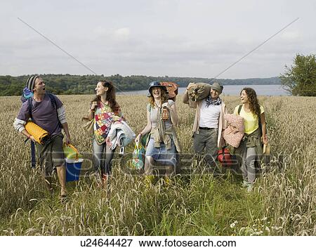Stock Photo - Five people walking together in field. Fotosearch
