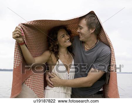 Man and woman standing under blanket View Large Photo Image Stock Image - Man and woman standing under blanket. Fotosearch