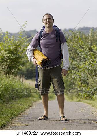 Man standing and looking into camera View Large Photo Image Stock Photo - Man standing and looking into camera. Fotosearch