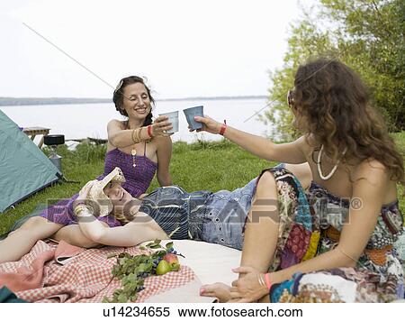 Three women on blanket in front of tent View Large Photo Image Stock Photography - Three women on blanket in front of tent. Fotosearch