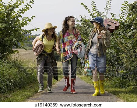Three women walking together on path View Large Photo Image Stock Photo - Three women walking together on path. Fotosearch