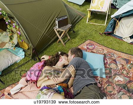 Woman and man laying kissing on blanket View Large Photo Image Stock Photo - Woman and man laying kissing on blanket. Fotosearch