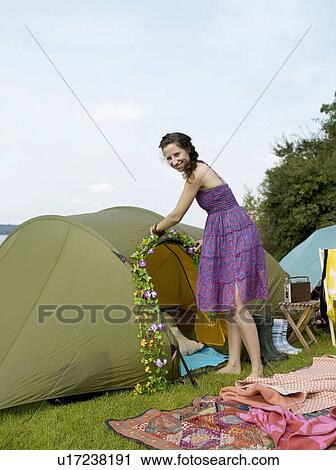 Woman decorating a tent with flowers View Large Photo Image Stock Image - Woman decorating a tent with flowers. Fotosearch