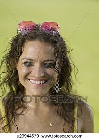 Woman looking and smiling into camera View Large Photo Image Stock Photo - Woman looking and smiling into camera. Fotosearch