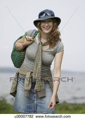 Stock Image - Woman looking into camera smiling. Fotosearch