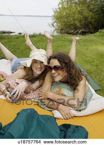 Women on blankets smiling into camera View Large Photo Image Picture - Women on blankets smiling into camera. Fotosearch