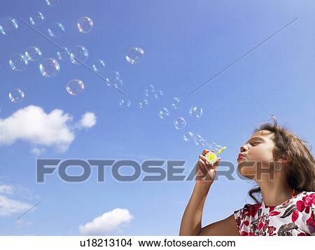 Little girl blowing bubbles. View Large Photo Image Picture - Little girl blowing bubbles.. Fotosearch
