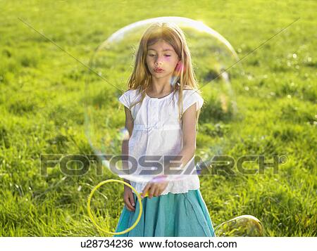 Little girl making soap bubbles. View Large Photo Image Stock Photograph - Little girl making soap bubbles.. Fotosearch