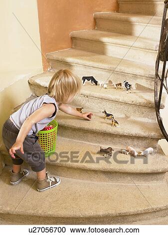 Stock Image - Little girl playing with animals.. Fotosearch