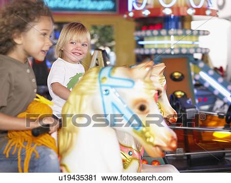 Little girls on merry go round. View Large Photo Image Stock Image - Little girls on merry go round.. Fotosearch