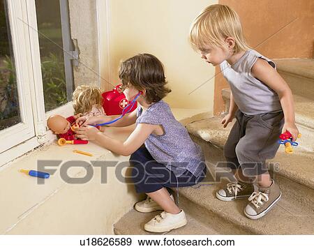 Little girls playing doctor with doll. View Large Photo Image Stock Photo - Little girls playing doctor with doll.. Fotosearch