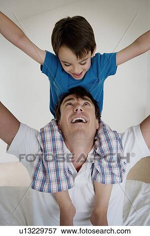Portrait of a father and son playing. View Large Photo Image Stock Photo - Portrait of a father and son playing.. Fotosearch