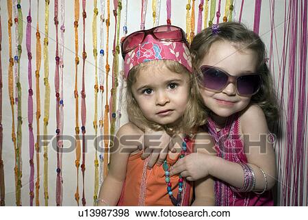 Two girls (2-4) dressed for a party. View Large Photo Image Stock Photo - Two girls (2-4) dressed for a party.. Fotosearch