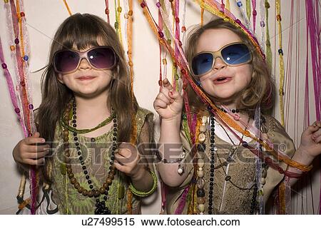 Stock Photography - Two girls (2-4) having fun in party clothes.. Fotosearch