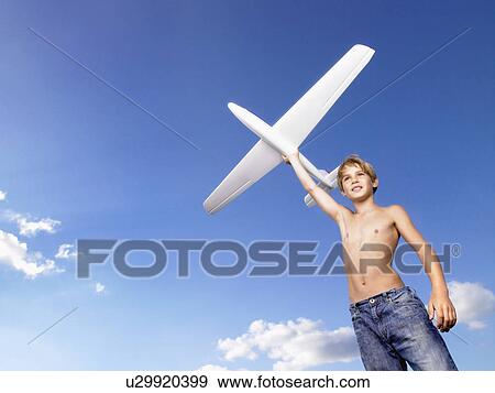 Young boy ready to send off an airplane. View Large Photo Image Stock Photo - Young boy ready to send off an airplane.. Fotosearch