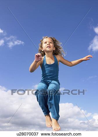 Young girl jumping in the air. View Large Photo Image Stock Photo - Young girl jumping in the air.. Fotosearch