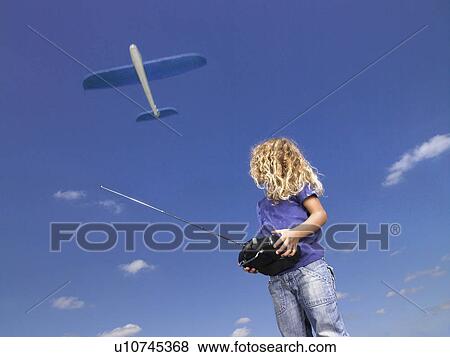 Young girl with remote-control. View Large Photo Image Stock Photo - Young girl with remote-control.. Fotosearch