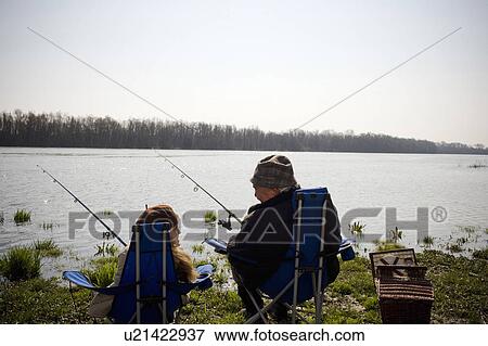 Grandfather and granddaughter (10-12) fishing by river, rear view View Large Photo Image Stock Photo - Grandfather and granddaughter (10-12) fishing by river, rear view. Fotosearch
