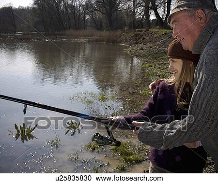 Grandfather teaching granddaughter (10-12) to fish in river, smiling View Large Photo Image Stock Image - Grandfather teaching granddaughter (10-12) to fish in river, smiling. Fotosearch