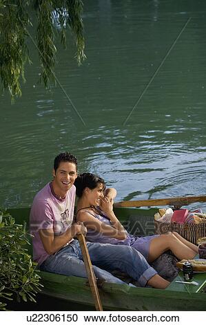 Man and woman in a boat relaxing View Large Photo Image Stock Image - Man and woman in a boat relaxing. Fotosearch