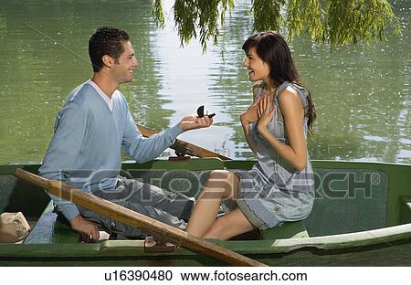 Man proposes to woman in boat View Large Photo Image Stock Image - Man proposes to woman in boat. Fotosearch