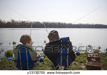 Senior couple fishing together by river, rear view View Large Photo Image Stock Photography - Senior couple fishing together by river, rear view. Fotosearch