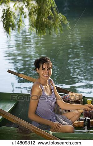 Woman having a picnic on boat View Large Photo Image Stock Image - Woman having a picnic on boat. Fotosearch