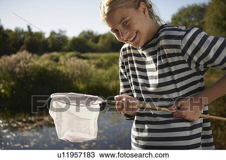 Young Woman by pond with fishing net. View Large Photo Image Stock Image - Young Woman by pond with fishing net.. Fotosearch