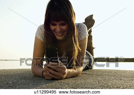 Girl holding mobile phone. View Large Photo Image Stock Photography - Girl holding mobile phone.. Fotosearch