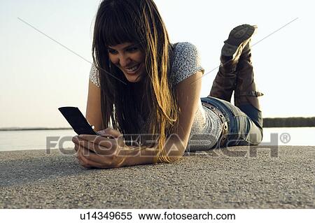 Stock Photography - Girl holding mobile phone.. Fotosearch