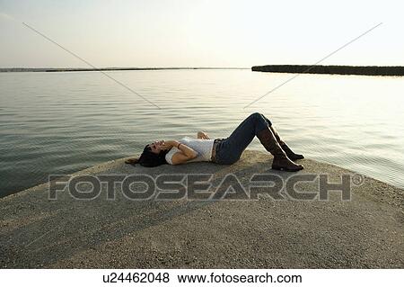 Girl lying down talking on mobile phone. View Large Photo Image Stock Photo - Girl lying down talking on mobile phone.. Fotosearch