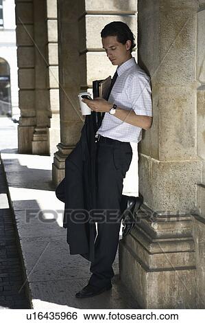 Stock Photograph - Man by the opera house in Hungary.. Fotosearch