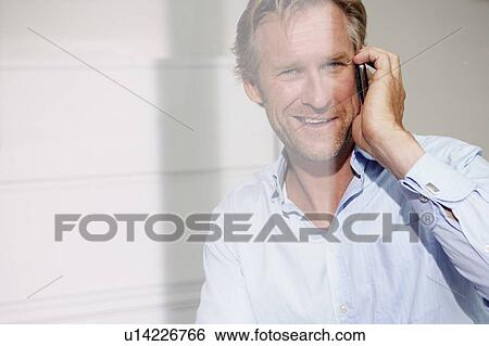 Man in office on telephone close-up with reflections. View Large Photo Image Stock Photograph - Man in office on telephone close-up with reflections.. Fotosearch