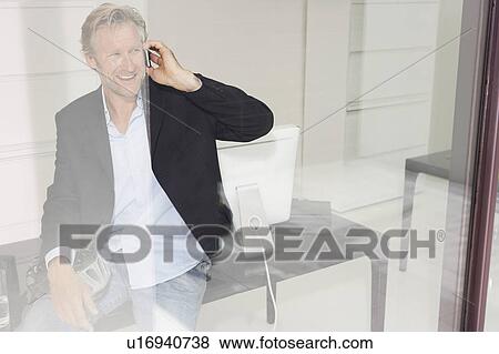 Man in office on telephone with reflections. View Large Photo Image Stock Photo - Man in office on telephone with reflections.. Fotosearch