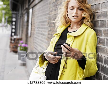 Stock Photo - Woman standing outdoors . Fotosearch