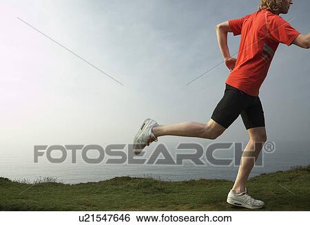 Detail of a Young man running. View Large Photo Image Stock Photograph - Detail of a Young man running.. Fotosearch